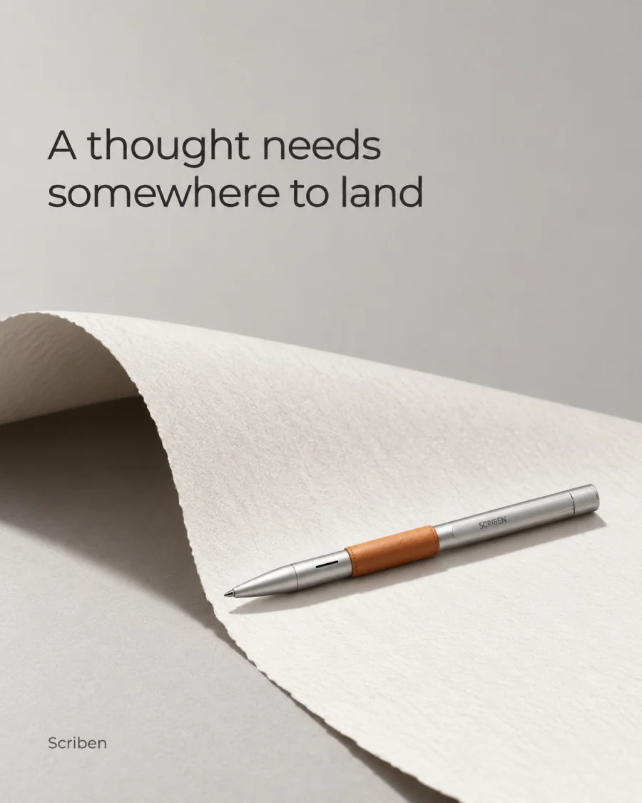 A thought needs somewhere to land. A pen on a curl of paper.